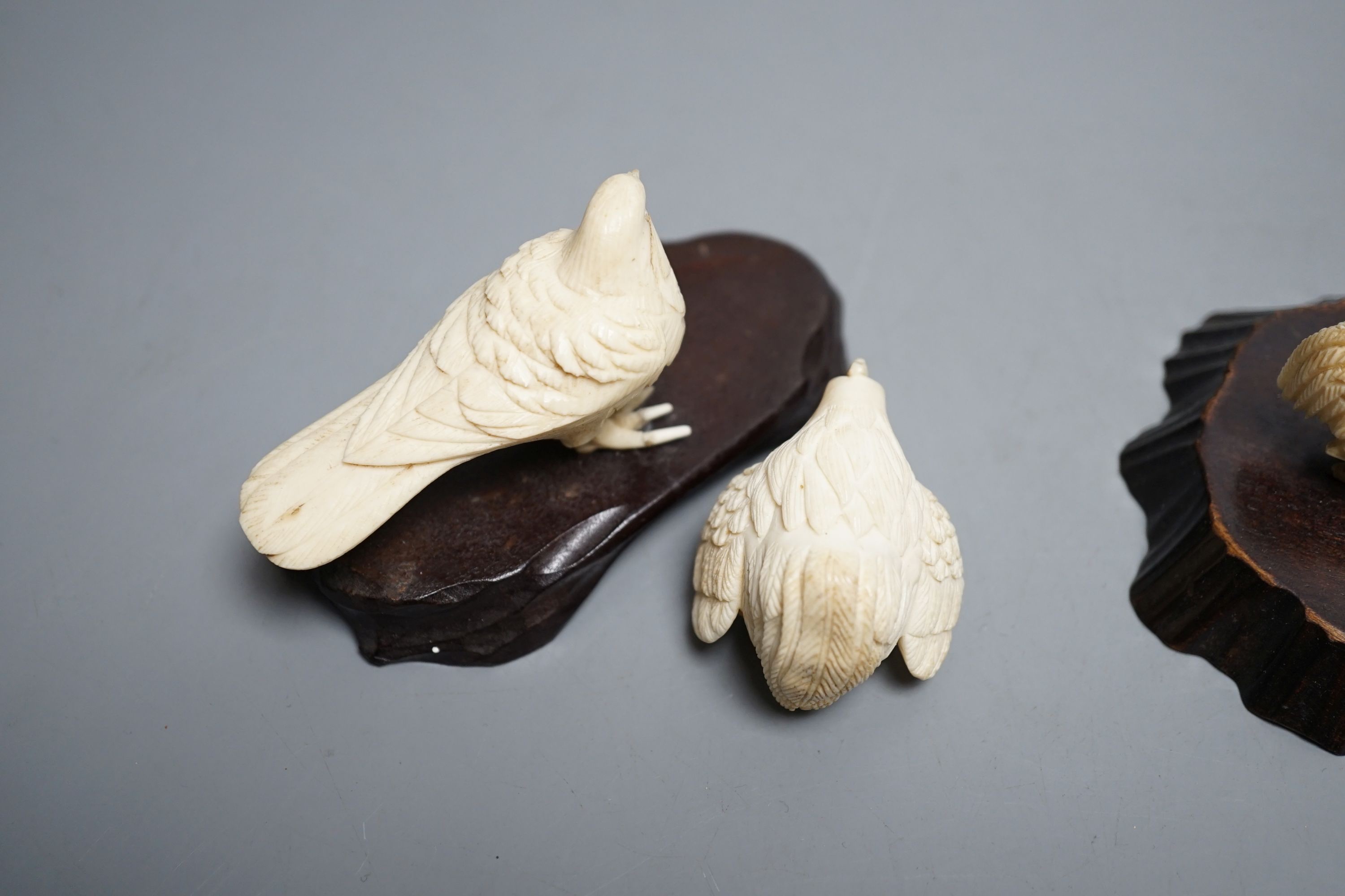A Japanese Meiji period ivory bird with mother of pearl eyes, a Japanese group of three chickens and Japanese copulating chickens